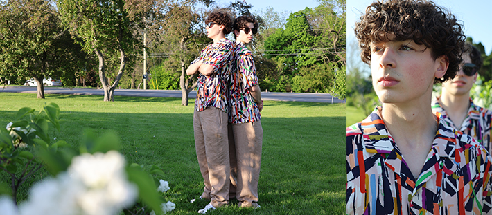 young adults in the park wearing graphic camp collar shirts and taupe linen pants